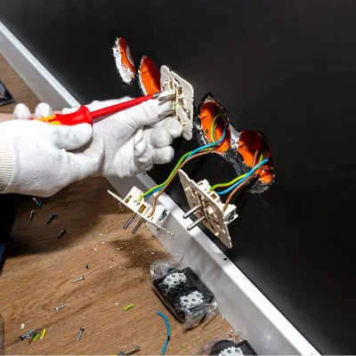 electrician-uses-red-screwdriver-screw-double-grounded-electrical-socket-row 1